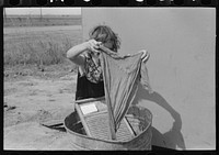 Twelve-year-old girl keeps house in trailer for her three brothers who are migrant workers, near Harlingen, Texas by Russell Lee