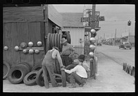 Group of men inspecting secondhand tires for sale, Corpus Christi, Texas by Russell Lee