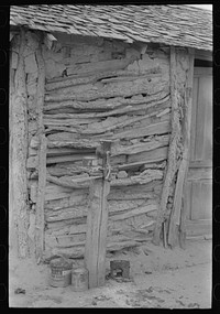 Detail of Mexican house made of sticks and mud. Corn grinder is on post in front. Crystal City, Texas by Russell Lee