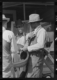  farmers talking on the streets of San Augustine, Texas by Russell Lee