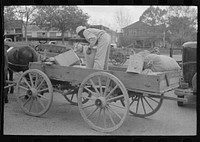 farmer loading supplies into his wagon, Saturday afternoon, San Augustine, Texas by Russell Lee