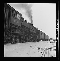 Freight operations on the Indiana Harbor Belt railroad between Chicago, Illinois and Hammond, Indiana. The crew is going to the yard "light," so the caboose is picked up and they are ready to go. Sourced from the Library of Congress.
