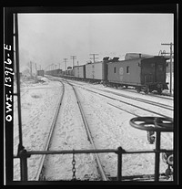 [Untitled photo, possibly related to: Freight operations on the Indiana Harbor Belt railroad between Chicago, Illinois and Hammond, Indiana. The conductor uses hand brakes on the caboose to stop it as it coasts down a siding]. Sourced from the Library of Congress.