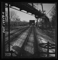 [Untitled photo, possibly related to: Freight train operations on the Chicago and Northwestern Railroad between Chicago and Clinton, Iowa. The train crosses a long steel bridge]. Sourced from the Library of Congress.