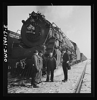 Freight train operations on the Chicago and Northwestern Railroad between Chicago and Clinton, Iowa. The crew, with exception of the fireman, chat while waiting for orders to pull out. Sourced from the Library of Congress.