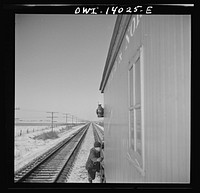 Freight train operations on the Chicago and Northwestern Railroad between Chicago and Clinton, Iowa. The rear brakeman hops on as the train starts again after waiting for a passenger train to go by. Sourced from the Library of Congress.