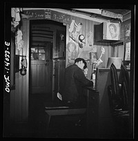 Freight train operations on the Chicago and North Western railroad between Chicago and Clinton, Iowa. As soon as the train gets under way, the conductor sits down to work on his bills and records. Sourced from the Library of Congress.