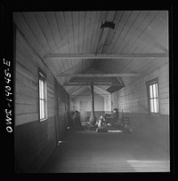 [Untitled photo, possibly related to: Freight train operations on the Chicago and Northwestern Railroad between Chicago and Clinton, Iowa. At the end of the trip, Conductor Wolfsmith waits at the little railroad station for a suburban train to take him back home to Chicago. A welder, who works at the rip tracks is trying to thaw out his frozen air hose]. Sourced from the Library of Congress.