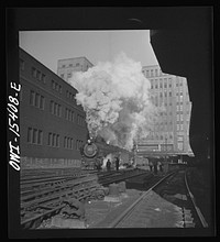 Chicago, Illinois. Double header Pennsylvania railroad train pulling out of Union station. The building in the background is the United States Post Office. Sourced from the Library of Congress.