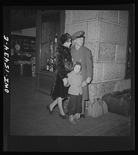 [Untitled photo, possibly related to: Chicago, Illinois. Soldier and his family waiting for a train at the Union Station]. Sourced from the Library of Congress.