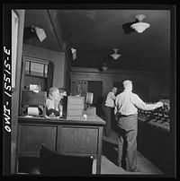 [Untitled photo, possibly related to: Chicago, Illinois. In the interlocking tower at Union Station. It is here that all inbound and outbound traffic is controlled. The men work entirely by the board, hardly ever looking out of a window to see an actual train]. Sourced from the Library of Congress.