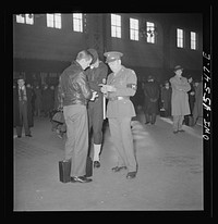 Chicago, Illinois. Military and Naval police help a recruit on his way at the Union Station. Sourced from the Library of Congress.