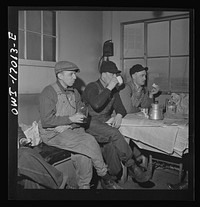 [Untitled photo, possibly related to: Daniel Senise at lunch in the work shanty at an Indiana Harbor Belt Line railroad yard. With him are (left) switchman John McCarthy and (right) switchman E.H. Albrecht]. Sourced from the Library of Congress.