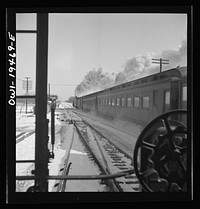 McCook (vicinity), Illinois. Passing an eastbound passenger train along the Atchison, Topeka, and Santa Fe Railroad, between Chicago and Chillicothe, Illinois. Sourced from the Library of Congress.