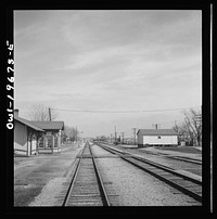 Floyd, Missouri. Going through the town on the Atchison, Topeka, and Santa Fe Railroad between Marceline, Missouri and Argentine, Kansas. The white building on the right is a potato barn. Sourced from the Library of Congress.