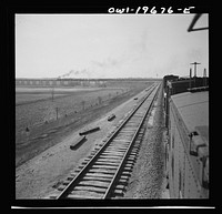 [Untitled photo, possibly related to: Sibley, Missouri. A freight train on the Atchison, Topeka, and Santa Fe Railroad between Marceline, Missouri and Argentine, Kansas going across the Missouri river]. Sourced from the Library of Congress.