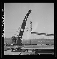 Topeka, Kansas. Breaking rails which have been found defective by the rail doctor car, at the test department of the Atchison, Topeka, and Santa Fe Railroad shops. The rail is dropped so as to crack at the point marked by the chalk marked arrow. The extent of the fissure can then be studied. Sourced from the Library of Congress.
