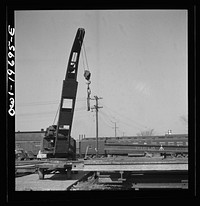 [Untitled photo, possibly related to: Topeka, Kansas. Breaking rails which have been found defective by the rail doctor car, at the test department of the Atchison, Topeka, and Santa Fe Railroad shops. The rail is dropped so as to crack at the point marked by the chalk marked arrow. The extent of the fissure can then be studied]. Sourced from the Library of Congress.