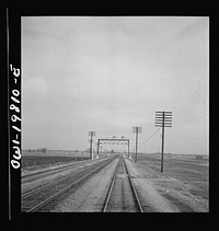 [Untitled photo, possibly related to: An Atchison, Topeka, and Santa Fe passenger train passing through the Flint mills district of Kansas. This is a famous stock feeding area]. Sourced from the Library of Congress.