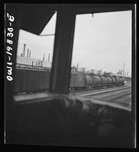 [Untitled photo, possibly related to: Wellington, Kansas. An oil refinery seen through the windows of the cupola of the caboose on the Atchison, Topeka, and Santa Fe Railroad between Emporia and Wellington, Kansas]. Sourced from the Library of Congress.