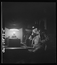 Waynoka, Oklahoma. Brakeman Jack Torbet, sitting at the window of the caboose pulling out of Waynoka, Oklahoma on the Atchison, Topeka, and Santa Fe Railroad. Sourced from the Library of Congress.