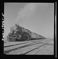 [Untitled photo, possibly related to: Kiowa, Kansas. Freight train pulling out on the Atchison, Topeka and Santa Fe Railroad between Wellington, Kansas and Waynoka, Oklahoma]. Sourced from the Library of Congress.