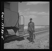 Miami, Texas. On the Atchison, Topeka and Santa Fe Railroad between Canadian, Texas and Amarillo, Texas. Brakeman C. B. Masable, waiting for the train to start after it has taken water. Sourced from the Library of Congress.