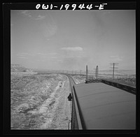 [Untitled photo, possibly related to: Hoover, Texas. An Atchison, Topeka, and Santa Fe train stopping to let an east-bound freight go by between Canadian and Amarillo, Texas]. Sourced from the Library of Congress.