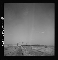 [Untitled photo, possibly related to: Hoover, Texas. An Atchison, Topeka, and Santa Fe train stopping to let an east-bound freight go by between Canadian and Amarillo, Texas]. Sourced from the Library of Congress.