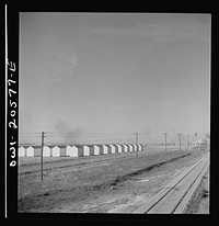 [Untitled photo, possibly related to: Hereford, Texas. Grain storage bins on the Atchison, Topeka, and Santa Fe Railroad between Amarillo, Texas and Clovis, New Mexico]. Sourced from the Library of Congress.