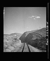 [Untitled photo, possibly related to: Coming out of the mountains on the Atchison, Topeka and Santa Fe Railroad between Vaughn and Belen, New Mexico into the Rio Grande River Valley. In the distance is a quarry on the mountainside where the railroad gets its rock for ballast]. Sourced from the Library of Congress.