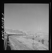 [Untitled photo, possibly related to: Quirk (vicinity), New Mexico. A train rounding a curve along the Atchison, Topeka and Santa Fe Railroad between Belen and Gallup, New Mexico]. Sourced from the Library of Congress.