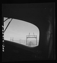 The San Francisco peaks, in the Sierra Nevada range near the California border, seen through the engineer's window of a diesel freight locomotive on the Atchison, Topeka and Santa Fe Railroad between Winslow and Seligman, Arizona. Sourced from the Library of Congress.