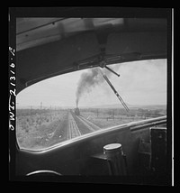 Ash Fork (vicinity), Arizona. Passing an eastbound freight train on the Atchison, Topeka and Santa Fe Railroad between Winslow and Seligman, Arizona. Sourced from the Library of Congress.