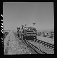 [Untitled photo, possibly related to: Yucca, Arizona. A section crew returning from work on the Atchison, Topeka and Santa Fe Railroad between Seligman, Arizona and Needles, California]. Sourced from the Library of Congress.
