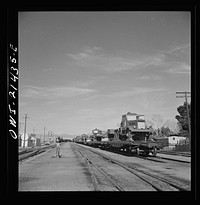 Ludlow, California. A train of military trucks and still another train waiting in the sidings because there is no room for them in the Barstow, California yard of the Atchison, Topeka, and Santa Fe Railroad. Sourced from the Library of Congress.
