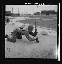 [Untitled photo, possibly related to: Warner Robins, Georgia. Air Service Command, Robins Field. Practicing change from a sitting to a prone position with the carbine]. Sourced from the Library of Congress.