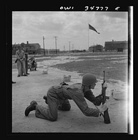 Warner Robins, Georgia. Air Service Command, Robins Field. Practicing change from a sitting to a prone position with the carbine. Sourced from the Library of Congress.