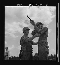 Warner Robins, Georgia. Air Service Command, Robins Field. Private Walter F. Guthrie, of Canadian, Texas, learning to handle a carbine. The instructor is Sergeant Dennis Maloney of Brooklyn, New York. Guthrie was a filling station operator in his home town; Maloney, a clerk in an A&P store. Both are now members of a depot group. Sourced from the Library of Congress.