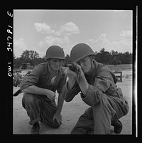 Warner Robins, Georgia. Air Service Command, Robins Field. Private Walter F. Guthrie, of Canadian, Texas, learning to handle a carbine. The instructor is Sergeant Dennis Maloney of Brooklyn, New York. Guthrie was a filling station operator in his home town; Maloney, a clerk in an A&P store. Both are now members of a depot group. Sourced from the Library of Congress.