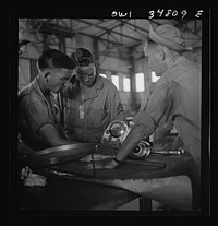 [Untitled photo, possibly related to: Warner Robins, Georgia. Air Service Command, Robins Field. Assembling the nose of a Pratt and Whitney engine]. Sourced from the Library of Congress.