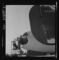 [Untitled photo, possibly related to: Warner Robins, Georgia. Air Service Command, Robins Field. Mechanics of an air depot group removing the cowling of one of the engines of a B-24 Liberator bomber]. Sourced from the Library of Congress.