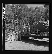 [Untitled photo, possibly related to: Warner Robins, Georgia. Air Service Command, Robins Field. Practicing picking up and loading of an old P-39 with a C3 truck and trailer]. Sourced from the Library of Congress.