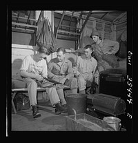 Greenville, South Carolina. Air Service Command. A scene in one of the barracks. The man on the left is cleaning his submachine gun. Sourced from the Library of Congress.