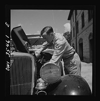 Bowman, South Carolina. Sergeant John Riley of the 25th service group, Air Service Command, on leave at his home. He is tuning up his old Ford, preparing to go see his girlfriend. Sourced from the Library of Congress.