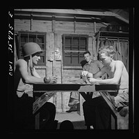 [Untitled photo, possibly related to: Greenville, South Carolina. Air Service Command. Men of the Quartermaster Truck Company of the 25th service group having a card game in one of the barracks]. Sourced from the Library of Congress.