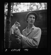 [Untitled photo, possibly related to: Greenville, South Carolina. Air Service Command. Lieutenant Rosen of the Quartermaster Truck Company, 25th service group, with a pet puppy]. Sourced from the Library of Congress.