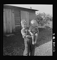 [Untitled photo, possibly related to: Migrant laborer's children. Mother was thirty-two years old, had had eleven children, two sets of twins, six are now living. She and her husband lost jobs in packinghouse because they cut down in help or closed after the "freeze-out." The older boy said "This little 'uns fell off so since we come here. It was so fat before. It's had colitis so bad. My daddy didn't know we was comin' to the wrong place this time. We've been lots of places. I don't like it here so well but I reckon we'll have to stay a smart while. My daddy had to turn back the car. He'd paid a lot off on it but he didn't git enough work here. Now we can't go nowheres else." Belle Glade, Florida.]. Sourced from the Library of Congress.