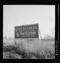 Billboards advertising various brands of fertilizer are seen very frequently all over the South.  This one near Laurinburg, North Carolina. Sourced from the Library of Congress.
