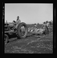 Tractor-driven combination bean planter and fertilizer machine used on many large tracts of land in Florida farming area. Muckland around Lake Okeechobee, Florida. Sourced from the Library of Congress.